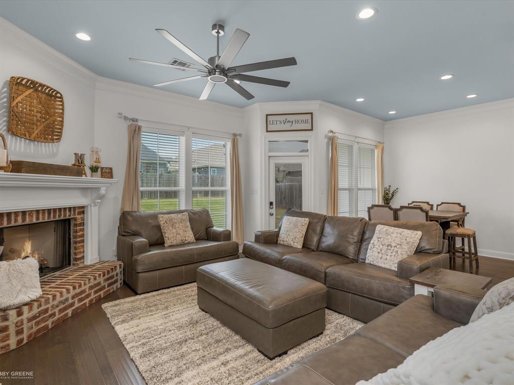690 Lessie Drive Stonewall, LA 71078 - Photo 5 of 29 Expansive living area featuring a brick fireplace with white mantel, wood-finish flooring, recessed lighting, and a contemporary ceiling fan