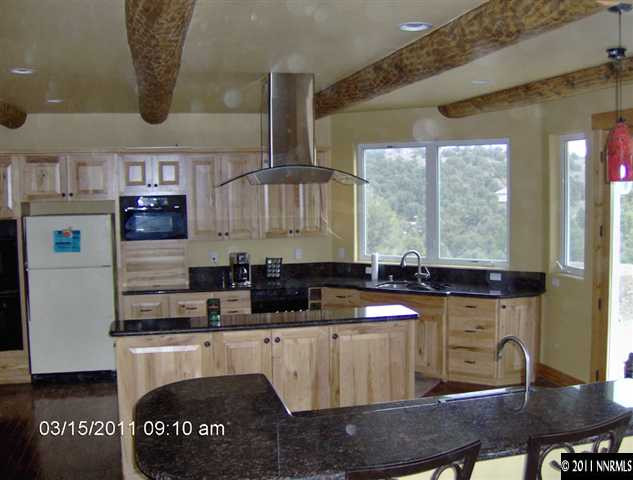 2620 Castle Peak Road Reno, NV 89521 - Photo 4 of 10 a kitchen with stainless steel appliances granite countertop a sink a stove a refrigerator a cabinets and chairs