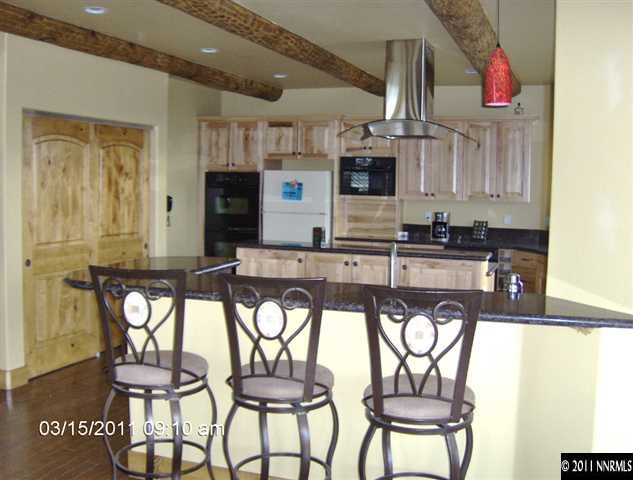 2620 Castle Peak Road Reno, NV 89521 - Photo 5 of 10 a kitchen with stainless steel appliances granite countertop a sink and a refrigerator