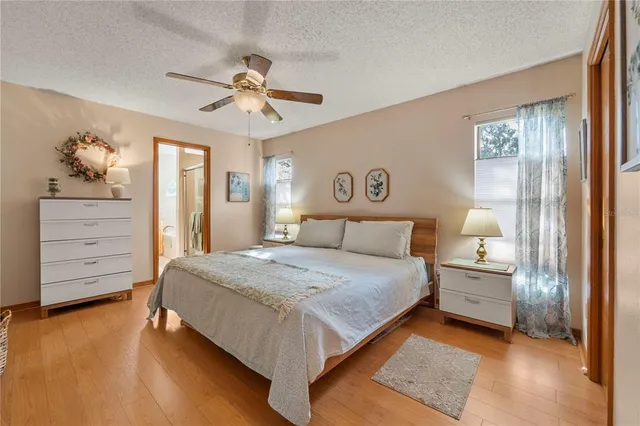 a bedroom with a large bed and a ceiling fan