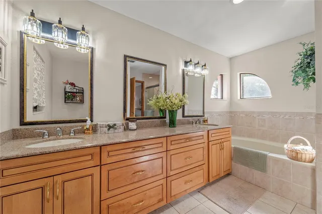 a bathroom with a shower sink and mirror