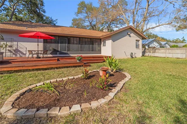 a view of a backyard with swimming pool
