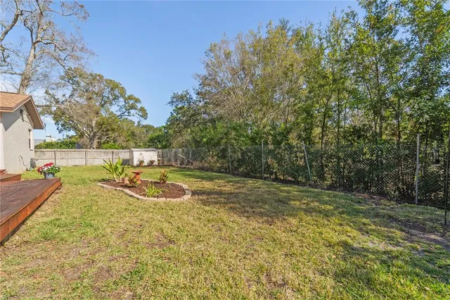 a view of a wooden floor and swimming pool in the backyard