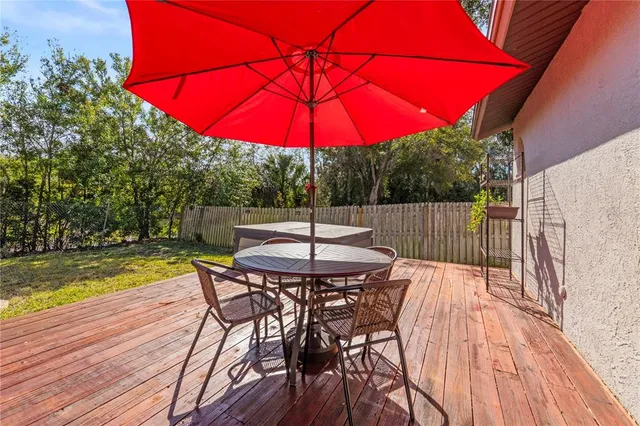 a view of a patio with furniture and a yard