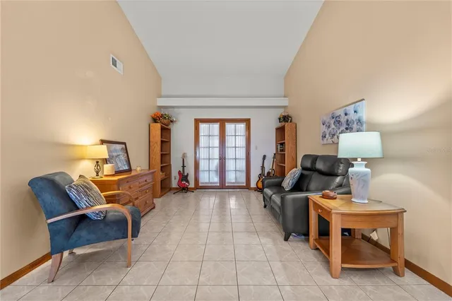 a living room with furniture and a lamp