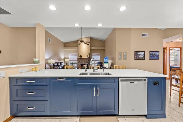a kitchen with a sink a cabinets and wooden floor