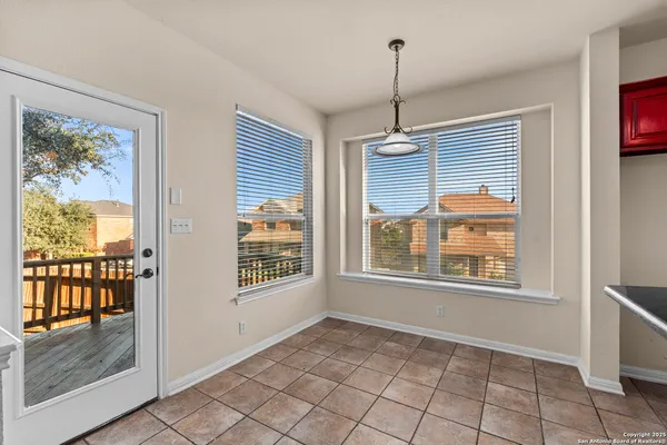 a view of an empty room with a window and a livingroom