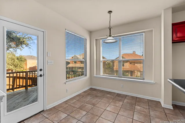 a view of an empty room with a window and a livingroom