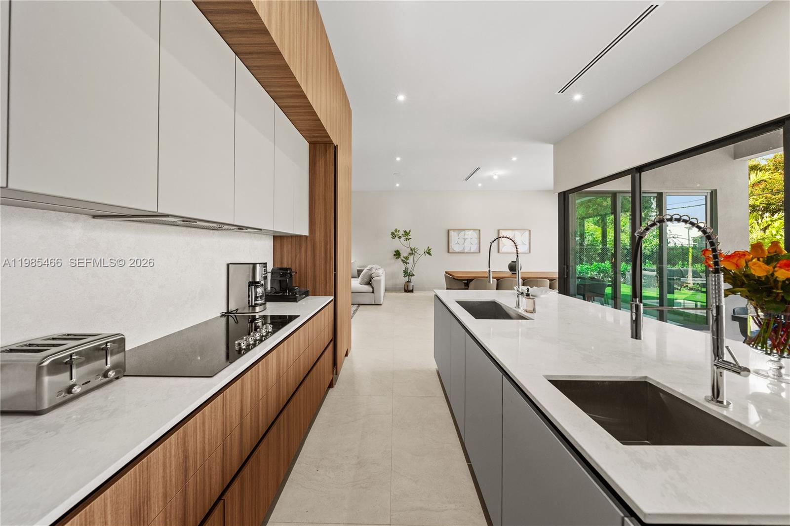 245 Northeast 116th Street Miami, FL 33161 - Photo 15 of 48 a kitchen with stainless steel appliances granite countertop a sink a stove and a wooden floors