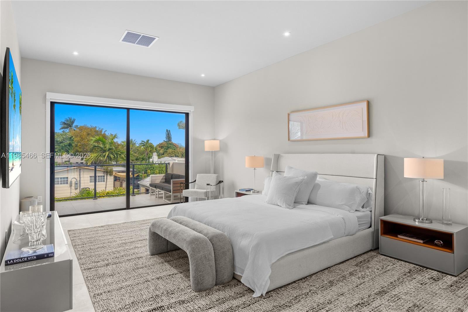 245 Northeast 116th Street Miami, FL 33161 - Photo 23 of 48 a bedroom with a large bed and a large window