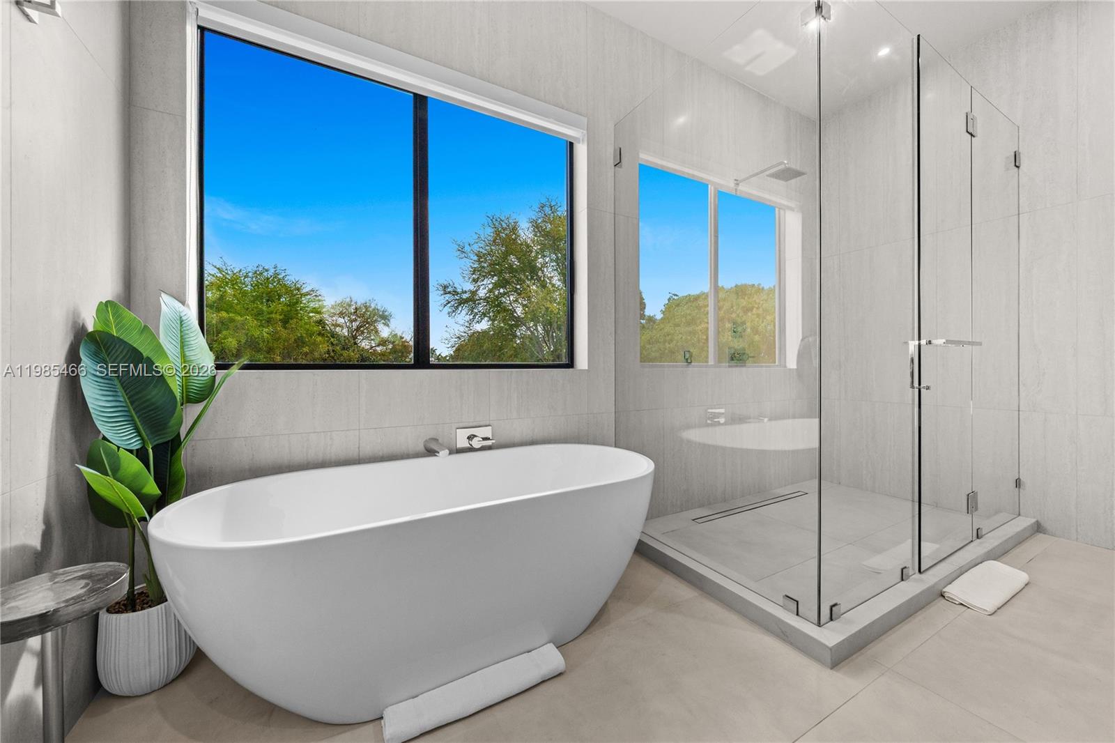 245 Northeast 116th Street Miami, FL 33161 - Photo 28 of 48 a white bath tub sitting in a bathroom next to a window
