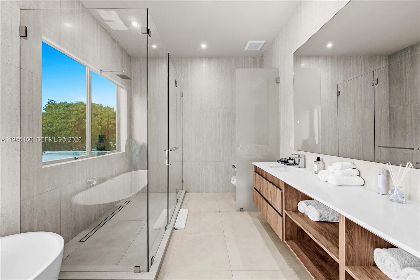 245 Northeast 116th Street Miami, FL 33161 - Photo 29 of 48 a bathroom with a double vanity sink and mirror with toilet