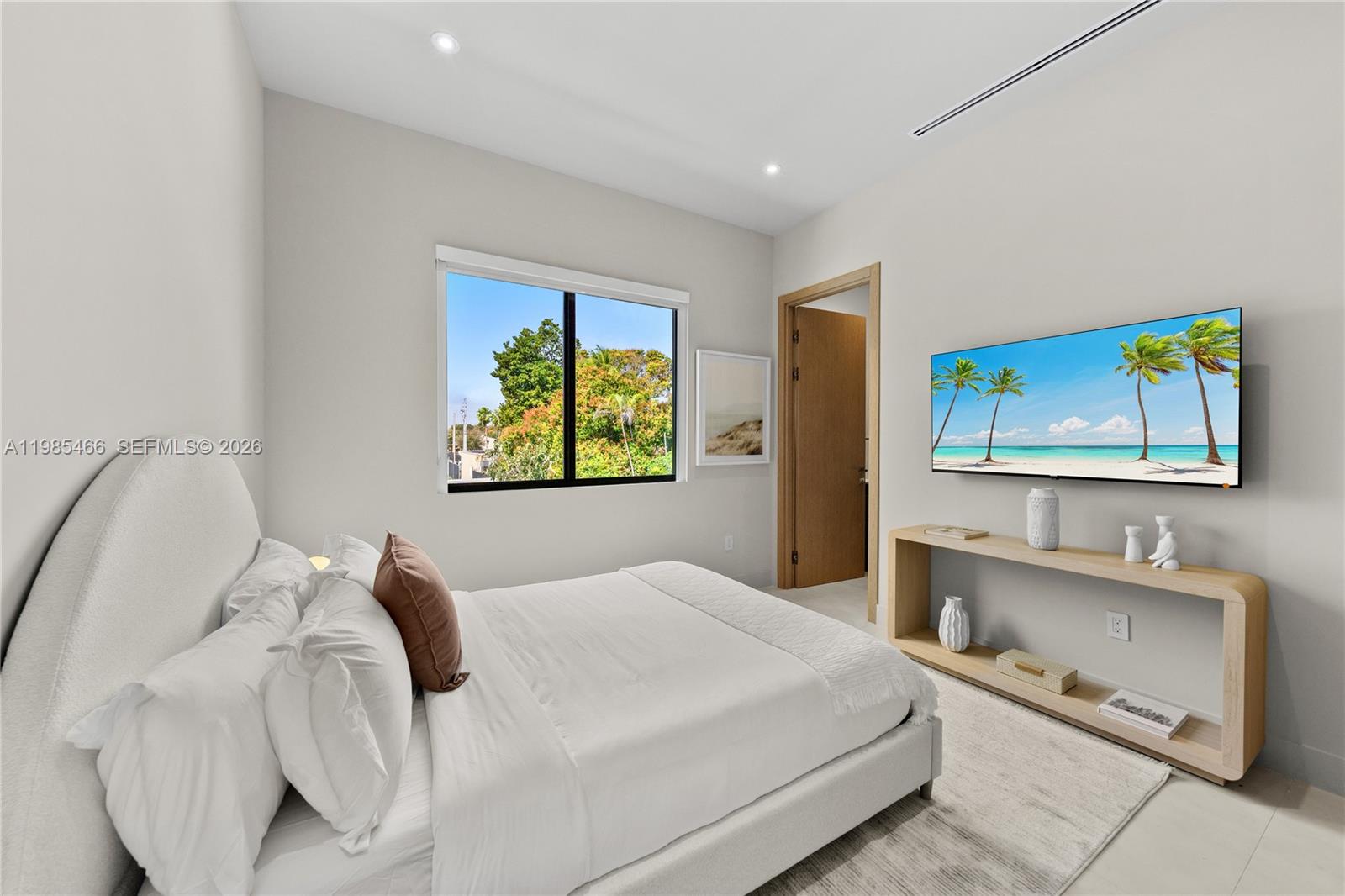 245 Northeast 116th Street Miami, FL 33161 - Photo 34 of 48 a bedroom with a bed and a flat screen tv