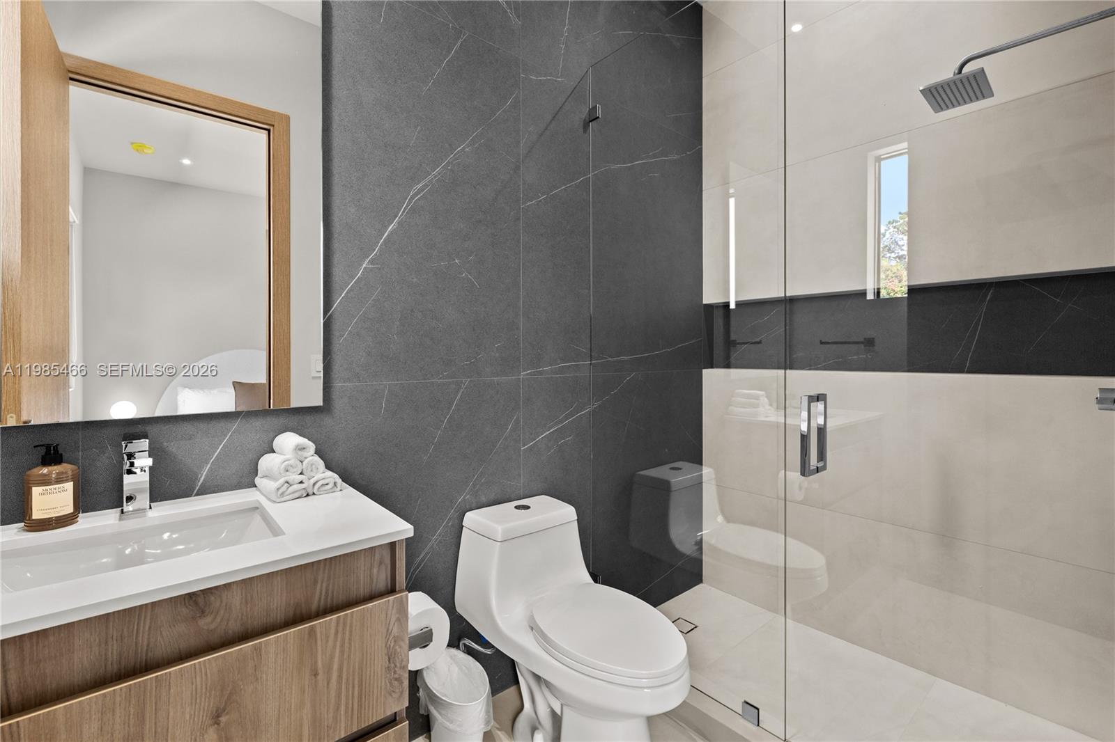 245 Northeast 116th Street Miami, FL 33161 - Photo 36 of 48 a bathroom with a sink toilet vanity and shower