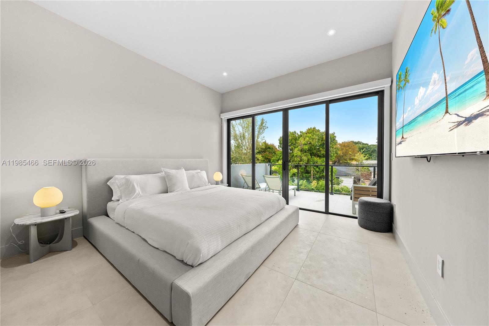 245 Northeast 116th Street Miami, FL 33161 - Photo 37 of 48 a spacious bedroom with a bed and a large window