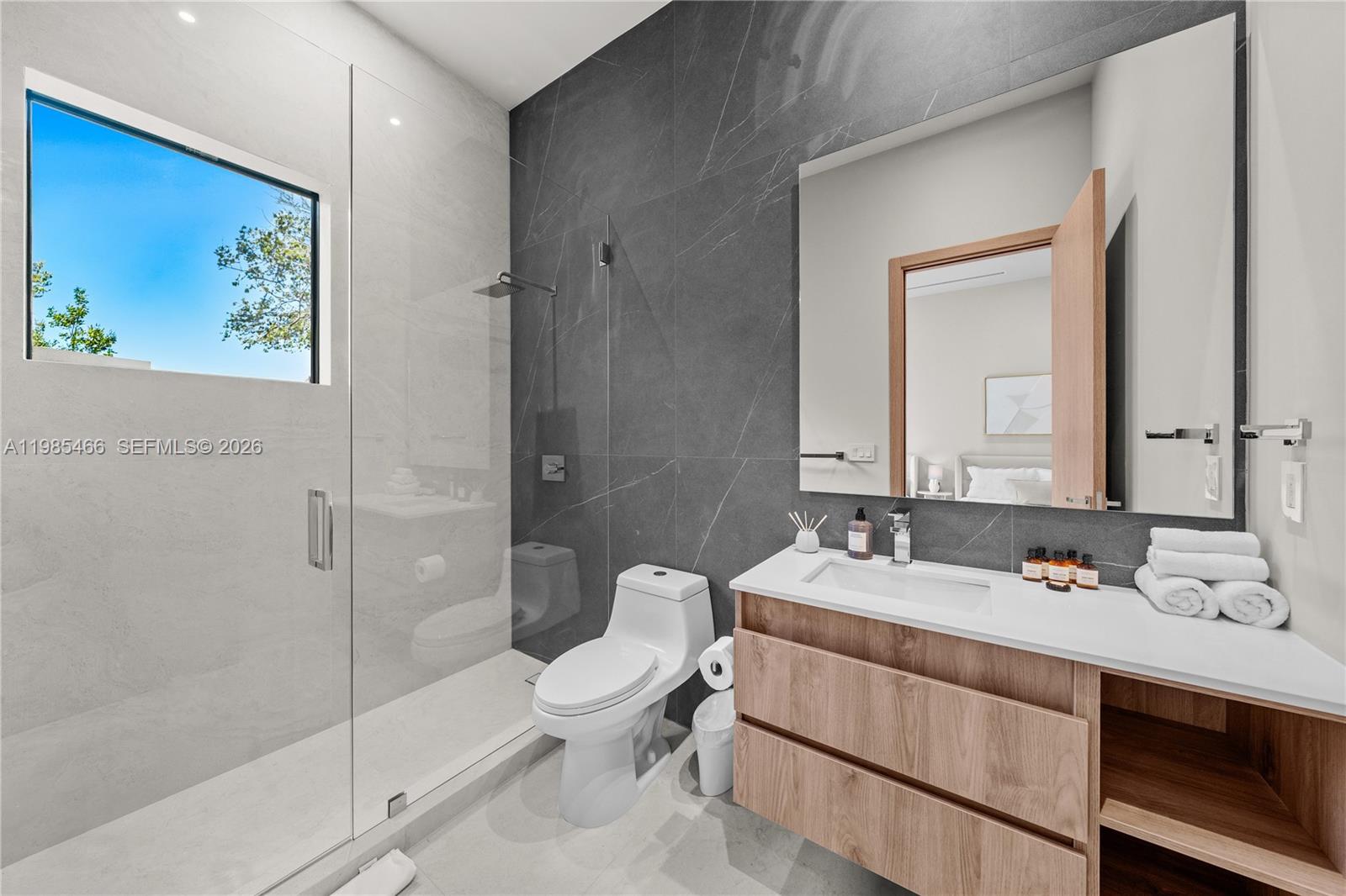 245 Northeast 116th Street Miami, FL 33161 - Photo 44 of 48 a en suite bathroom with a double vanity sink mirror and toilet