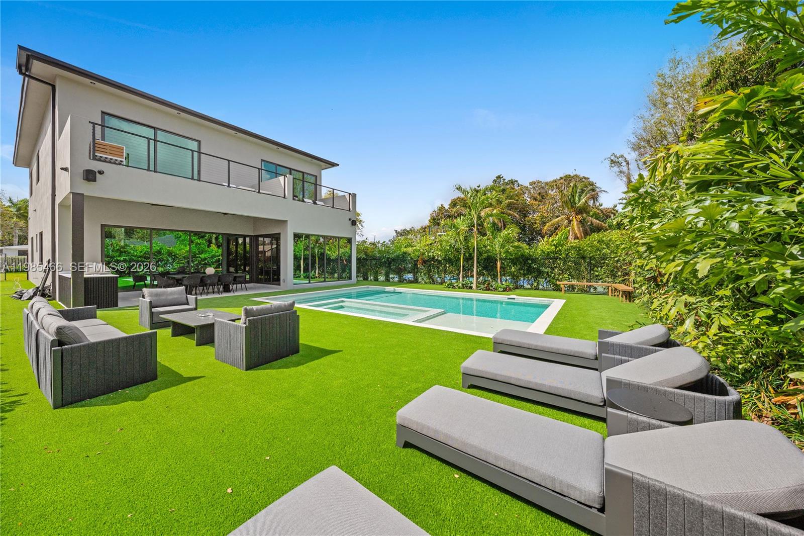 245 Northeast 116th Street Miami, FL 33161 - Photo 6 of 48 a view of a patio with couches chairs and a yard