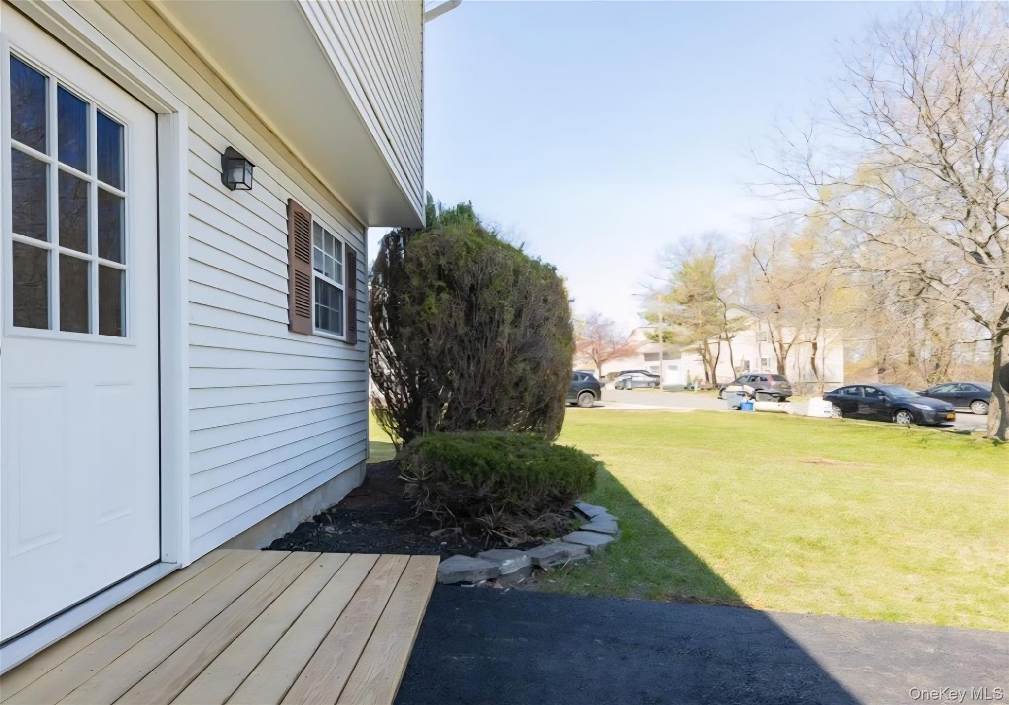 41 Albacon Road Nanuet, NY 10954 - Photo 2 of 6 View of green lawn with a deck