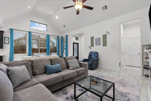 a living room with furniture and a large window