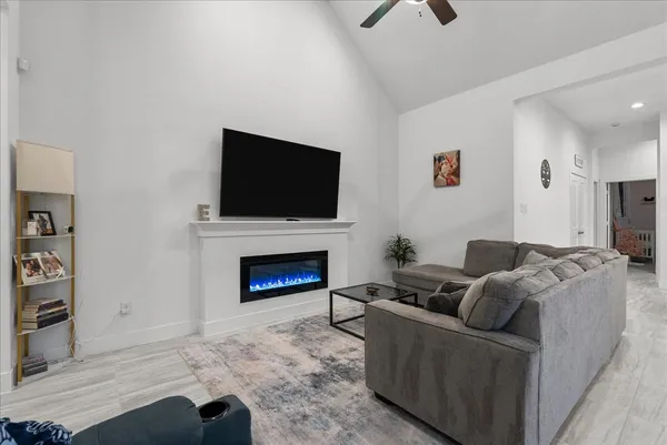 a living room with furniture and a fireplace