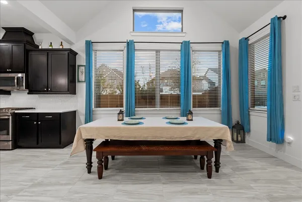 a living room with furniture a flat screen tv and a table