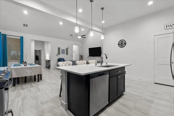 a kitchen with granite countertop a refrigerator and a stove