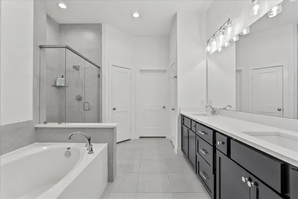 a en suite bathroom with a sink a large mirror and a shower