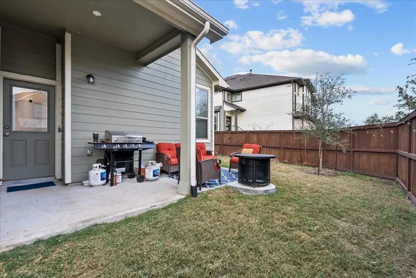 a backyard of a house with barbeque oven fire pit and outdoor seating