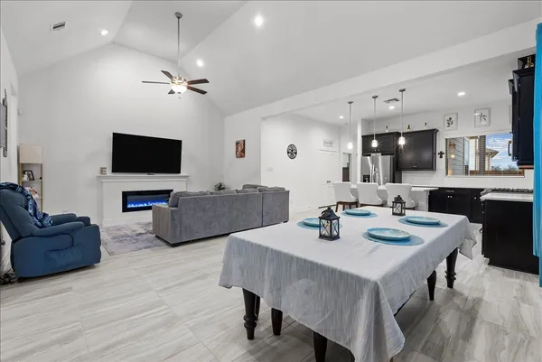 a view of a dining room with furniture and a flat screen tv