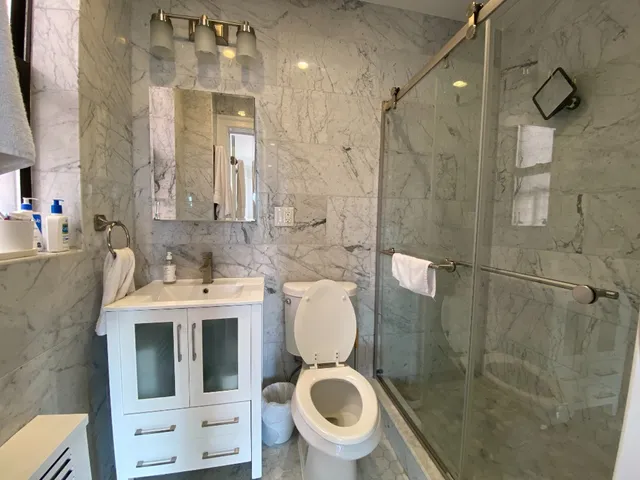 a bathroom with a toilet sink and shower