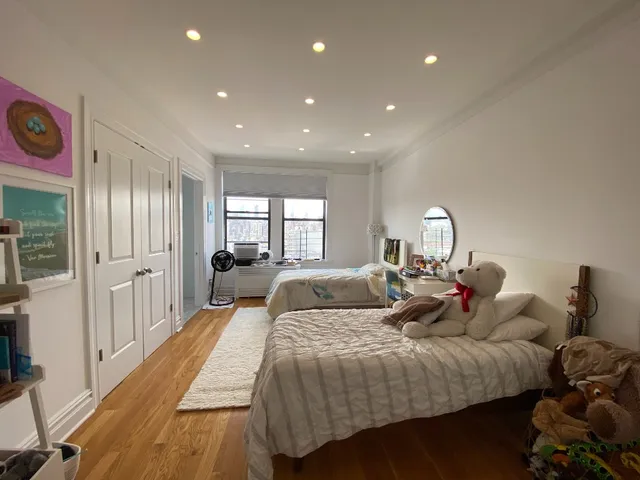 a bed room with two bed and a large mirror