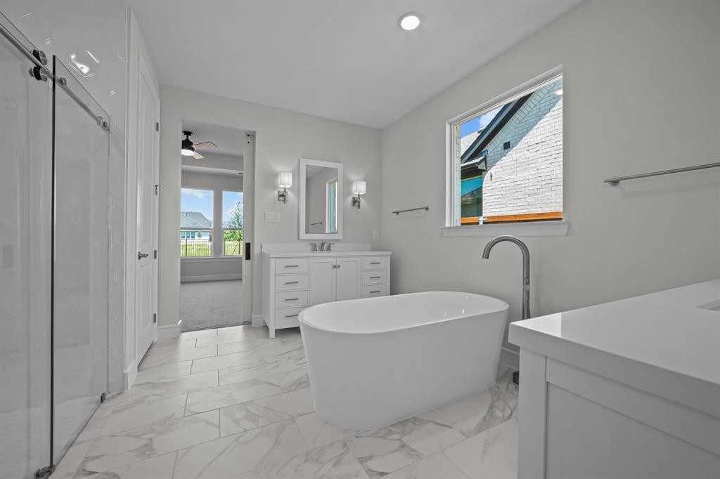 11549 Wulstone Road Fort Worth, TX 76052 - Photo 14 of 35 a bathroom with a sink a bathtub and a shower