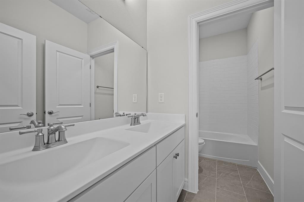 11549 Wulstone Road Fort Worth, TX 76052 - Photo 22 of 35 a bathroom with a sink and a mirror
