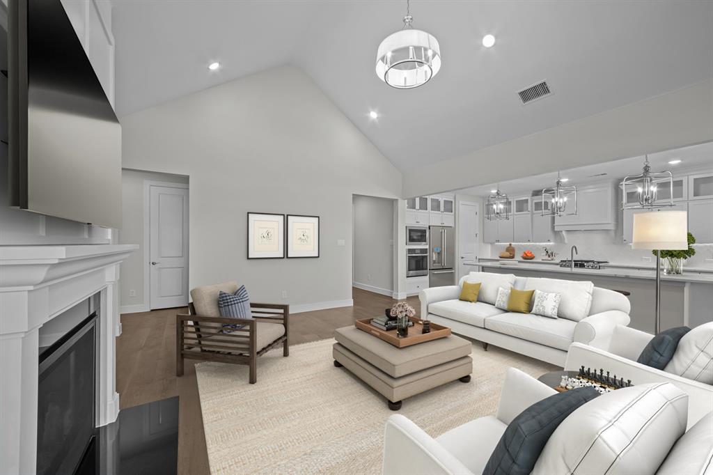 11549 Wulstone Road Fort Worth, TX 76052 - Photo 5 of 35 a living room with furniture kitchen view and a fireplace