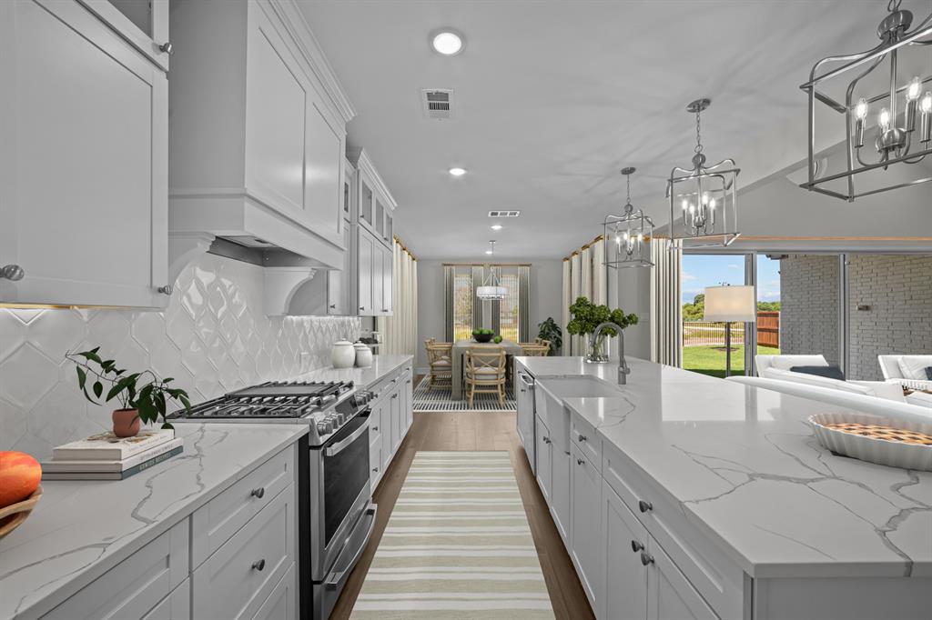 11549 Wulstone Road Fort Worth, TX 76052 - Photo 8 of 35 a large kitchen with stainless steel appliances lots of counter space and wooden floor