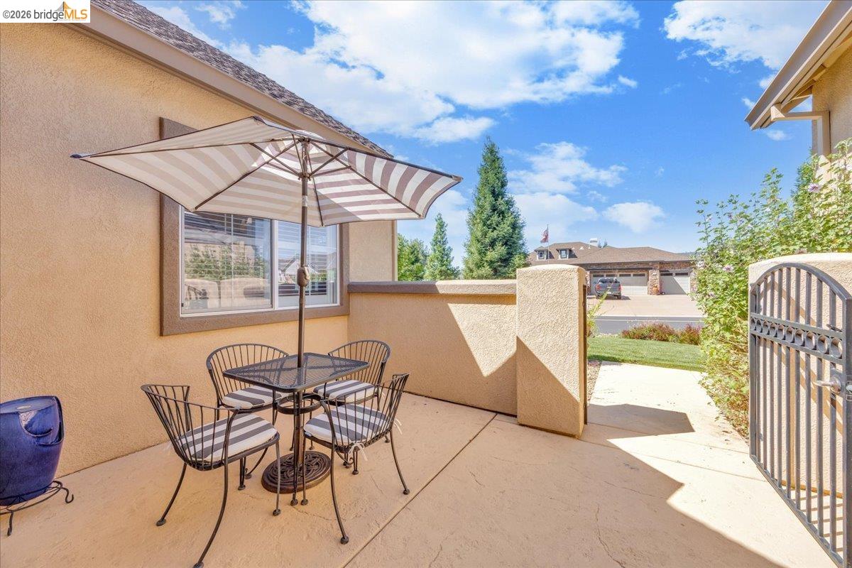 158 Rock Ridge Lane Copperopolis, CA 95228 - Photo 8 of 72 Private sitting area on the front patio with stucco walls and concrete flooring