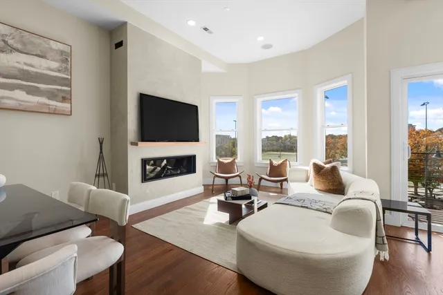 a living room with fireplace furniture and a flat screen tv