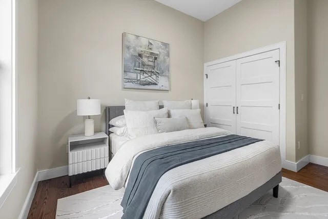 a bedroom with bed and painting on the wall