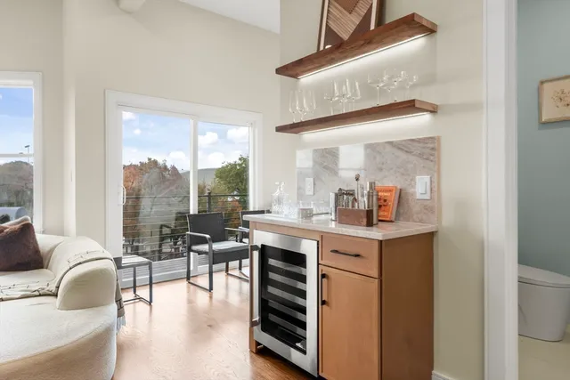 a kitchen with a table chairs stove and wooden floor