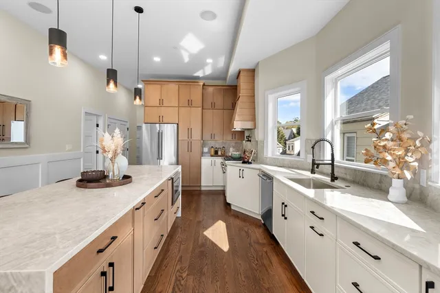 a large kitchen with kitchen island white cabinets and white appliances
