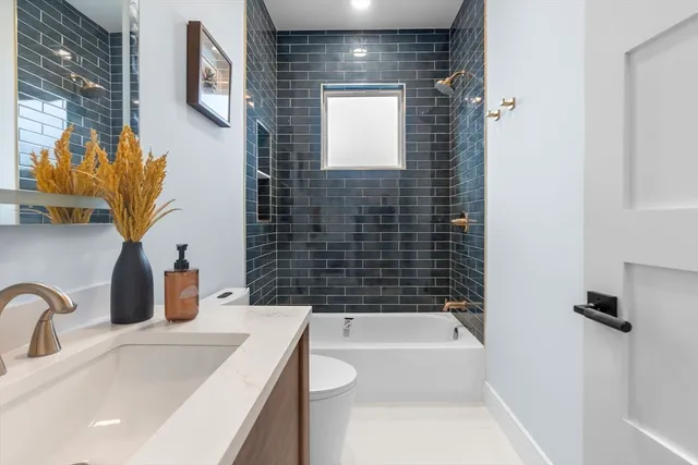 a bathroom with a sink a bathtub and shower