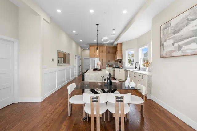 a large kitchen with a table and chairs