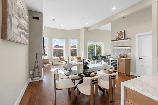 a living room with fireplace furniture and a large window