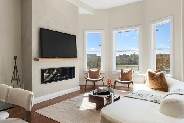 a living room with furniture fireplace and flat screen tv