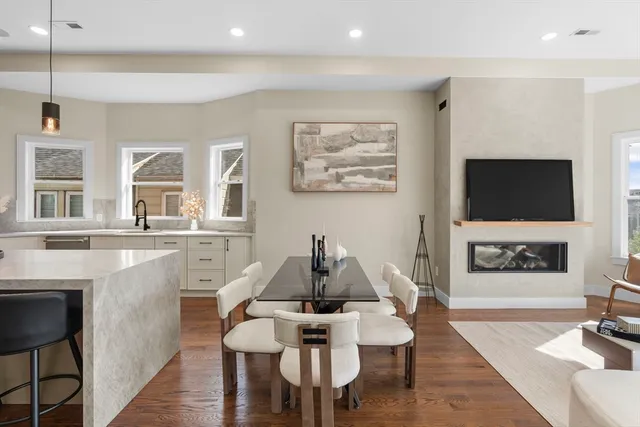 a living room with furniture a flat screen tv and kitchen view