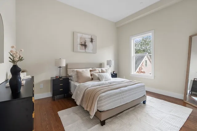 a bedroom with a bed and painting on the wall