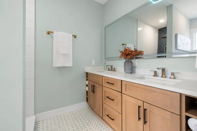 a bathroom with a sink a vanity and mirror