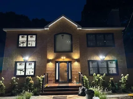 a front view of a house with plants