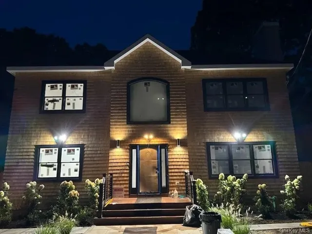 a front view of a house with plants