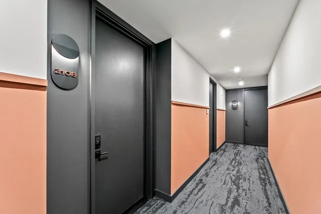 a view of hallway with wooden floor